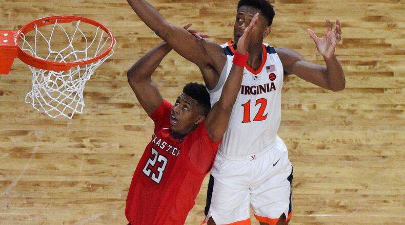 De'Andre Hunter reaches for the ball over Jarrett Culver in overtime.