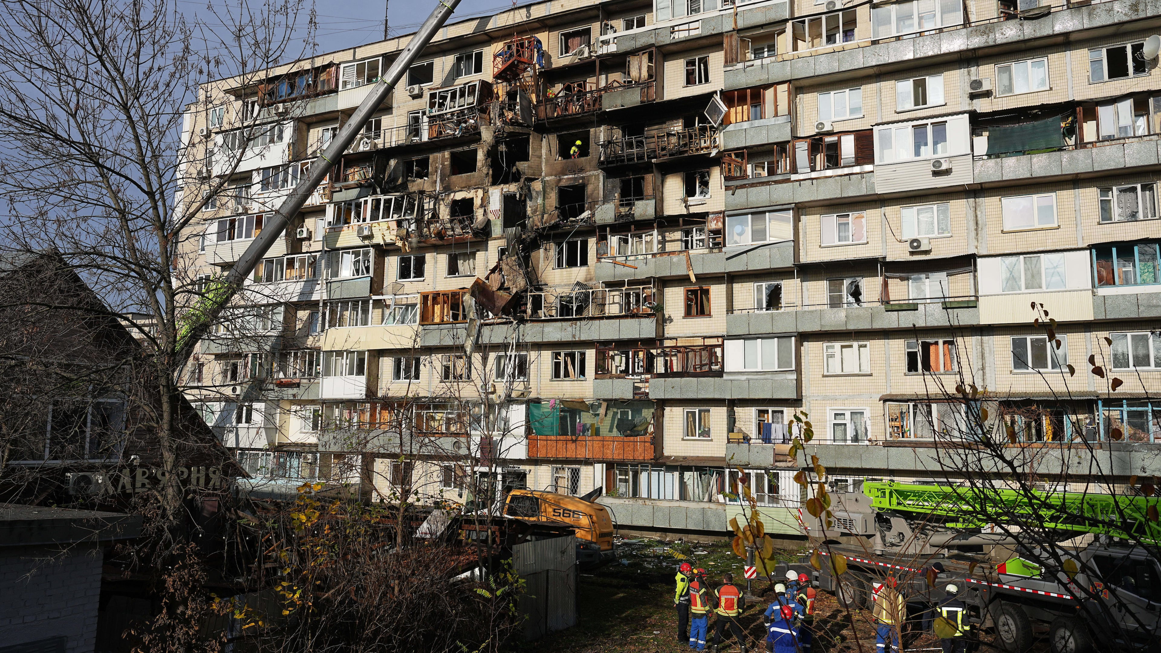 Rescuers work on the scene of a building damaged after a Russian attack in Kyiv, Ukraine, on Friday, Nov. 14, 2025. (AP Photo/Efrem Lukatsky)