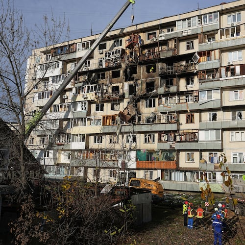 Rescuers work on the scene of a building damaged after a Russian attack in Kyiv, Ukraine, on Friday, Nov. 14, 2025. (AP Photo/Efrem Lukatsky)