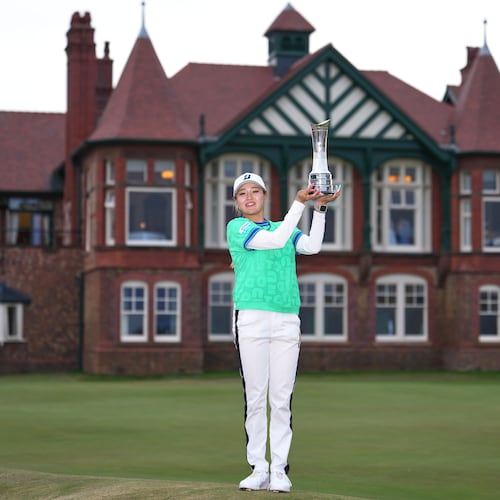 Shiho Kuwaki, of Japan, holds up the trophy after winning the Women's British Open golf championship in Lytham St Annes, England, Sunday, Aug. 2, 2026. (AP Photo/Jon Super)