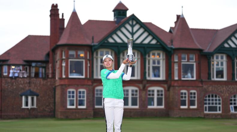Shiho Kuwaki, of Japan, holds up the trophy after winning the Women's British Open golf championship in Lytham St Annes, England, Sunday, Aug. 2, 2026. (AP Photo/Jon Super)