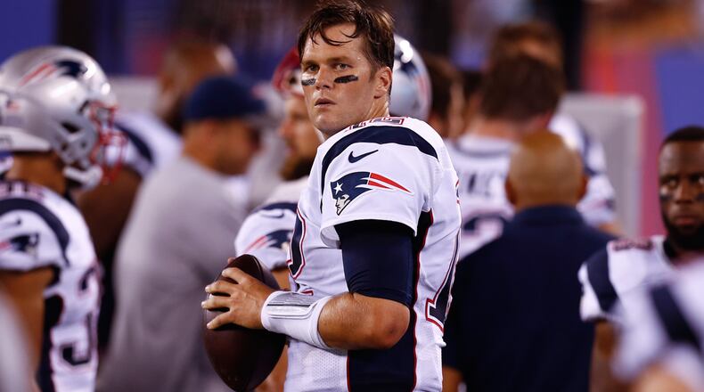 Tom Brady #12 of the New England Patriots warms up on the sidelines during their preseason game against the New York Giants at MetLife Stadium on September 1, 2016 in East Rutherford, New Jersey.