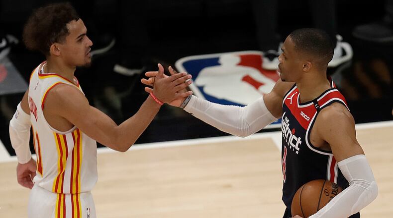 Wizards' Russell Westbrook is congratulated by Hawks' Trae Young after an NBA basketball game Monday, May 10, 2021, in Atlanta. Westbrook recorded his 182nd career triple-double, passing Oscar Robertson for the most in NBA history.