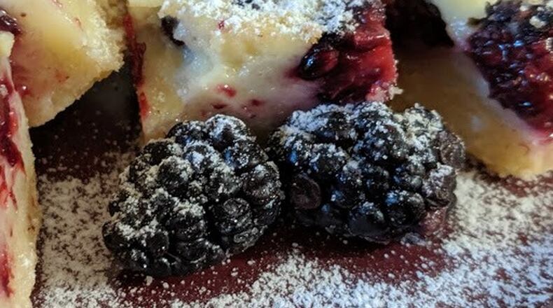 With Blackberry Custard Bars, one of the recipes in “Decadent Fruit Desserts” by Jackie Bruchez, the blackberries take center stage. PHOTO AND STYLING BY PAULA PONTES