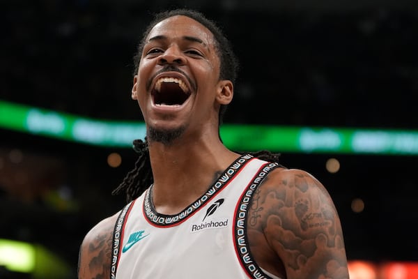 Memphis Grizzlies guard Ja Morant celebrates during the second half of an NBA play-in tournament basketball game against the Dallas Mavericks, Friday, April 18, 2025, in Memphis, Tenn. (AP Photo/George Walker IV)