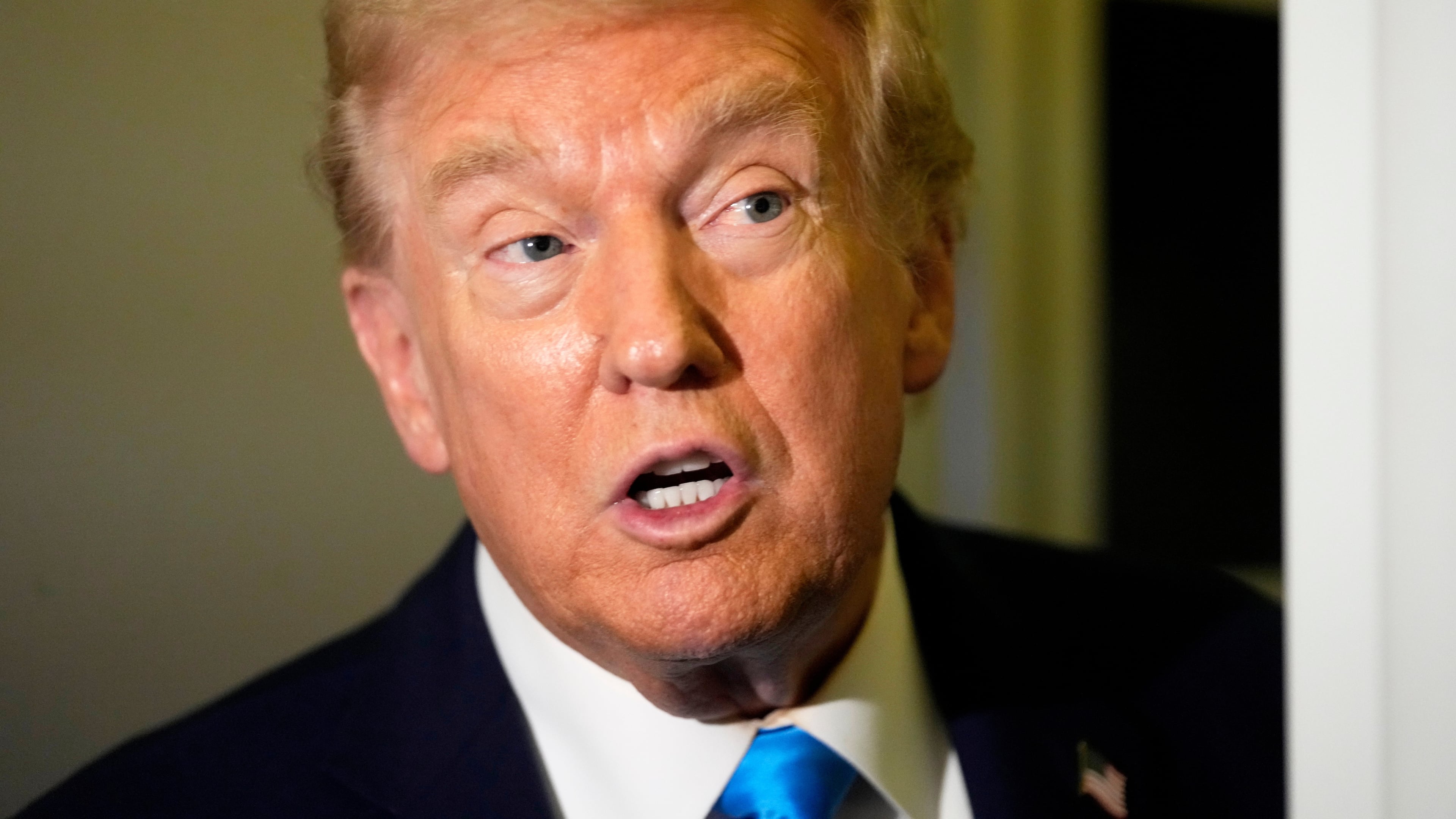 President Donald Trump speaks with reporters aboard Air Force One at Al Udeid Air Base in Doha, Qatar, Saturday, Oct. 25, 2025. (AP Photo/Mark Schiefelbein)