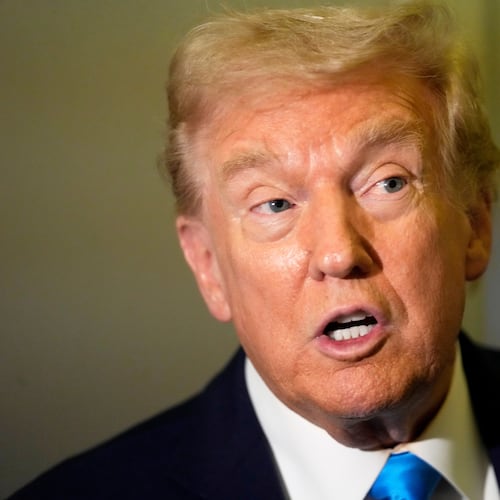 President Donald Trump speaks with reporters aboard Air Force One at Al Udeid Air Base in Doha, Qatar, Saturday, Oct. 25, 2025. (AP Photo/Mark Schiefelbein)