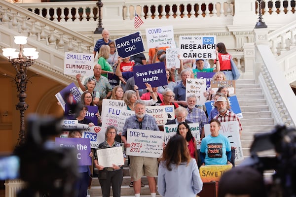 Former CDC employees and supporters gather on the Capitol stairs for a news conference after meeting with Democratic legislators. (Natrice Miller/AJC)