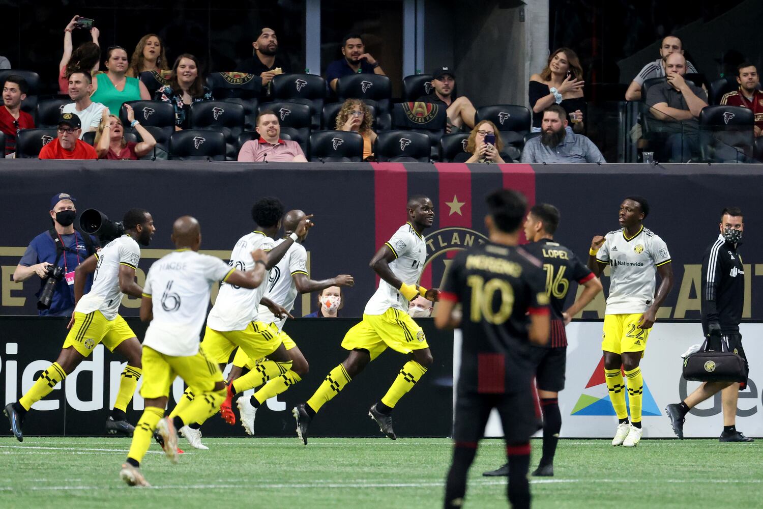 Columbus Crew defender Jonathan Mensah (4, center) reacts with teammates after the goal against Atlanta United in the second half. JASON GETZ FOR THE ATLANTA JOURNAL-CONSTITUTION