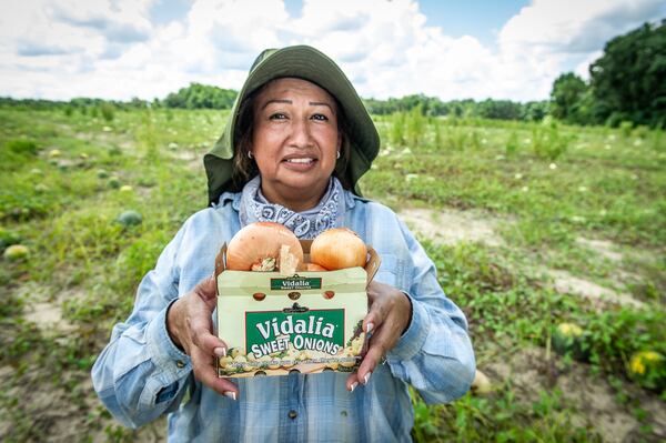 Maria Fajardo, a farmworker, shows off some of her harvest. Fajardo has worked throughout the pandemic, and is calling on political leaders to give more support to Hispanic communities. Her story is included in the Latino Community Fund's Hispanic Heritage Month video and photo project, called "Our Essential Heroes." (Courtesy of Hector Amador)