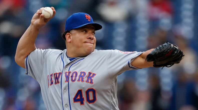 FILE - In this Oct. 1, 2016, file photo, New York Mets starting pitcher Bartolo Colon throws in the first inning of a baseball game against the Philadelphia Phillies, in Philadelphia. A person familiar with the situation says the Atlanta Braves have added another 40-year-old to their starting rotation, agreeing to terms with Bartolo Colon. The person spoke on condition of anonymity to The Associated Press because no announcement is expected from the Braves until next week on the reported $12.5 million, one-year deal with the 43-year-old Colon. (AP Photo/Laurence Kesterson, File)