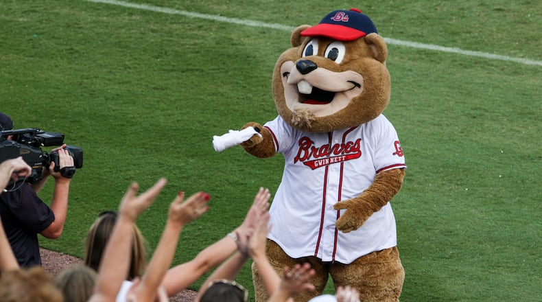 Chopper, the groundhog mascot of the Gwinnett Braves, hands out T-shirts to fans at a game. Credit: Karl Moore/Gwinnett Braves.