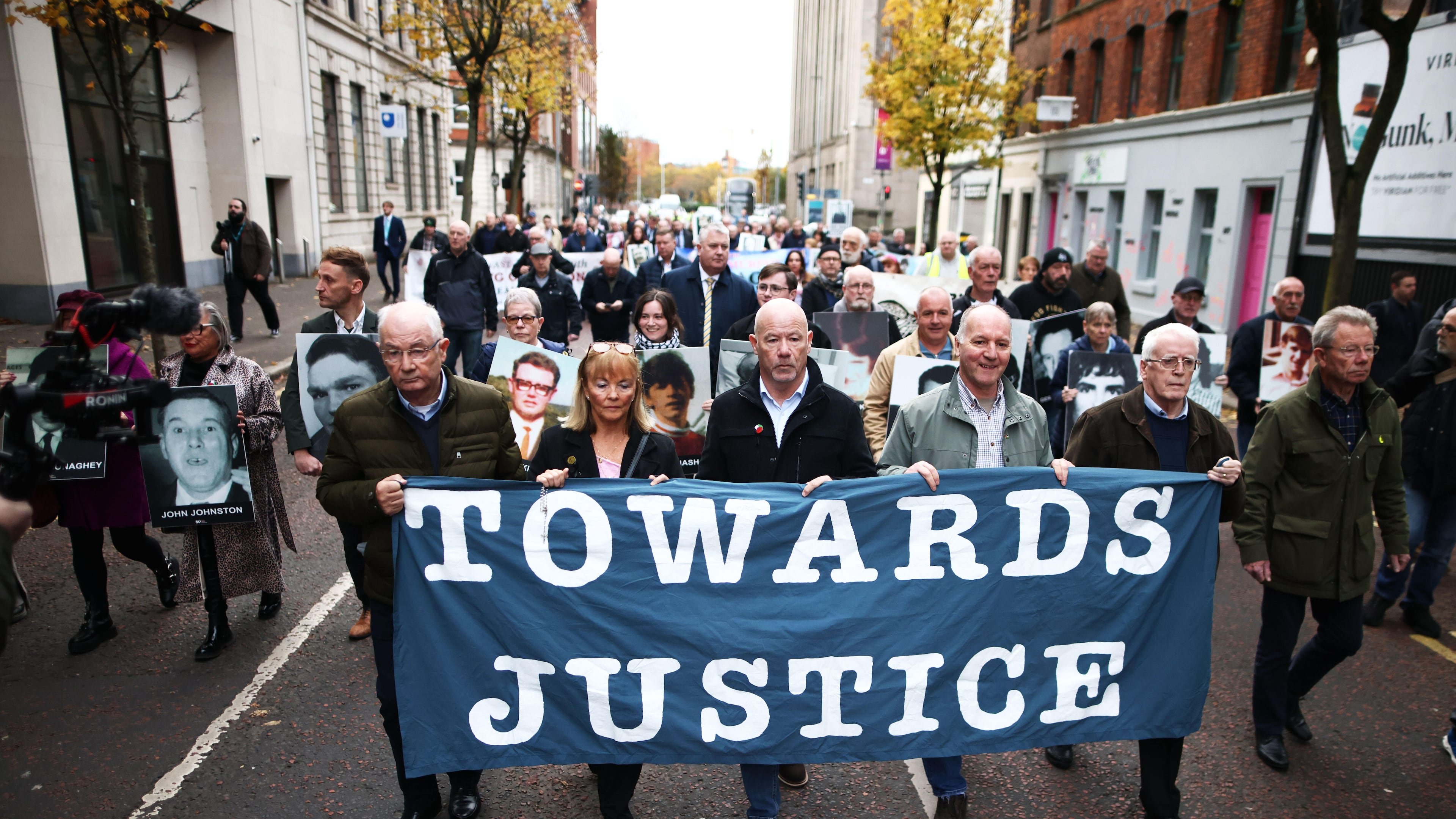 Relatives and supporters of the victims of the 1972 Bloody Sunday massacre march to Belfast Crown Court ahead of the verdict on the trial of a British soldier identified only as Soldier F, Belfast, in Northern Ireland, Thursday, Oct. 23, 2025. (AP Photo/Peter Morrison)