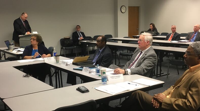 Gwinnett County ethics board members (from left) Terri R. Duncan, Herman Pennamon, David Will and Charles Rousseau watch a video on the county's ethics ordinance Friday.