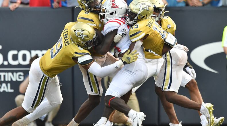 Ole Miss running back Ulysses Bentley is brought down by Georgia Tech's defensive line during the second half Saturday at Bobby Dodd Stadium. (Hyosub Shin / Hyosub.Shin@ajc.com)
