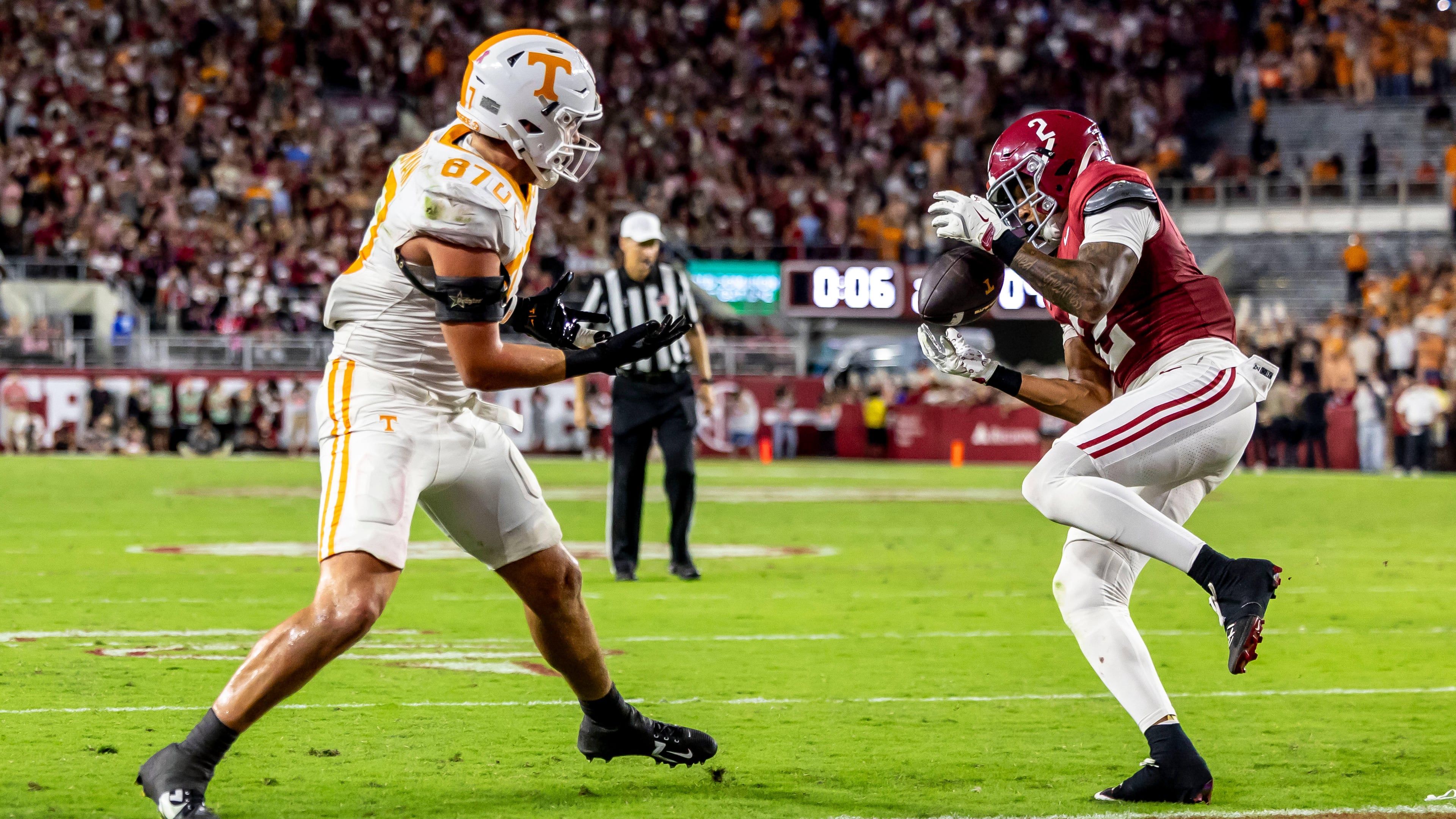 Alabama defensive back Zabien Brown (2) grabs an interception meant for Tennessee tight end Miles Kitselman (87) and returns it 99 yards for a pick-six touchdown on the final play of the first half during an NCAA college football game, Saturday, Oct. 18, 2025, in Tuscaloosa, Ala. (AP Photo/Vasha Hunt)