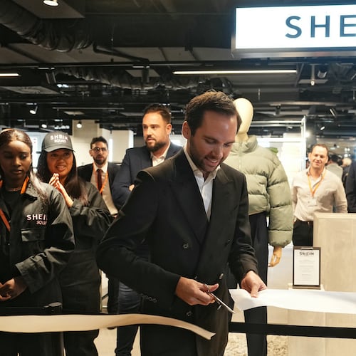 The director of the Bazar de l'Hotel de Ville (BHV) department store Karl-Stephane Cottendin cuts the ribbon at the opening Shein's first physical store in Paris, Wednesday, Nov. 5, 2025. ( Dimitar Dilkoff, Pool via AP)
