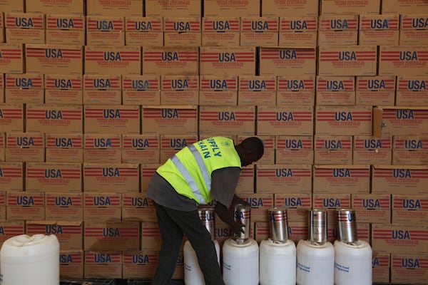 A man arranges USAID humanitarian aid inside a warehouse run by the World Food Programme (WFP) at Kakuma Refugee Camp in Turkana, Kenya Tuesday, June 3, 2025. (AP Photo/Andrew)