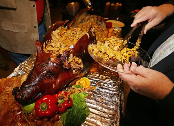 With proceeds to benefit the state food banks, maybe hogs are the only ones left objecting to the annual Wild Hog Supper. Photo: CURTIS COMPTON/AJC