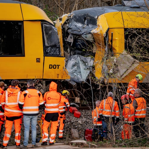 Emergency personnel work at the site where two trains collided near Hilleroed, Denmark, on Thursday, April 23, 2026. (Mads Claus Rasmussen/Ritzau Scanpix via AP)