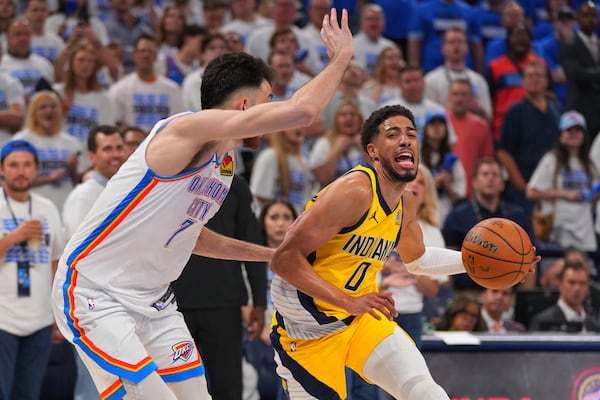 Indiana Pacers guard Tyrese Haliburton (0) drives past Oklahoma City Thunder forward Chet Holmgren (7) during the second half of Game 5 of the NBA Finals basketball series, Monday, June 16, 2025, in Oklahoma City. (AP Photo/Kyle Phillips)