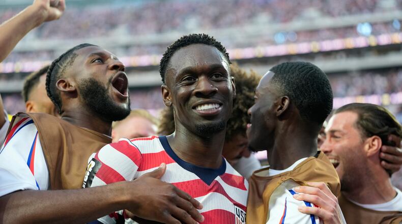 United States' Folarin Balogun, center, celebrates scoring his side's third goal against Paraguay with teamates during the World Cup Group D soccer match in Inglewood, Calif., near Los Angeles, Friday, June 12, 2026. (AP Photo/Andre Penner)