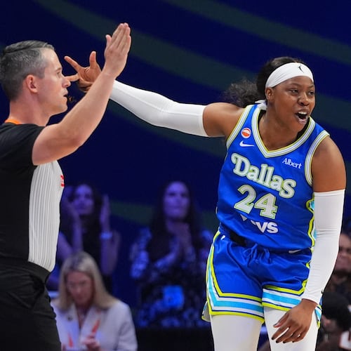 Dallas Wings guard Arike Ogunbowale reacts to scoring a three pointer during the first half of a WNBA basketball game against the Washington Mystics in Arlington, Texas, Monday, May 18, 2026. (AP Photo/LM Otero)