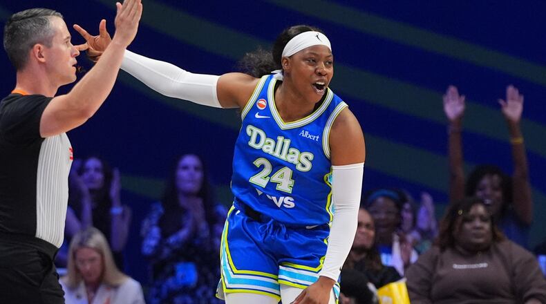Dallas Wings guard Arike Ogunbowale reacts to scoring a three pointer during the first half of a WNBA basketball game against the Washington Mystics in Arlington, Texas, Monday, May 18, 2026. (AP Photo/LM Otero)