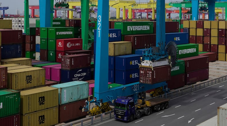 FILE - A crane loads a shipping container into a truck at an automated container port in Tianjin, China, Friday, Aug. 29, 2025. (AP Photo/Mahesh Kumar A., File)
