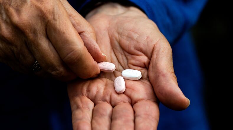 Mary Ann Neilsen holds her last Paxlovid pills while recovering from COVID-19 in Santa Barara, Calif., on Jan. 6, 2022. (Alex Welsh/The New York Times)