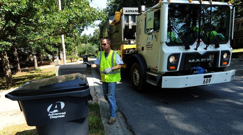 During the recent change in trash haulers to Advanced Disposal from Waste Management in Canton, the city says it found itself short of recycling carts. AJC FILE