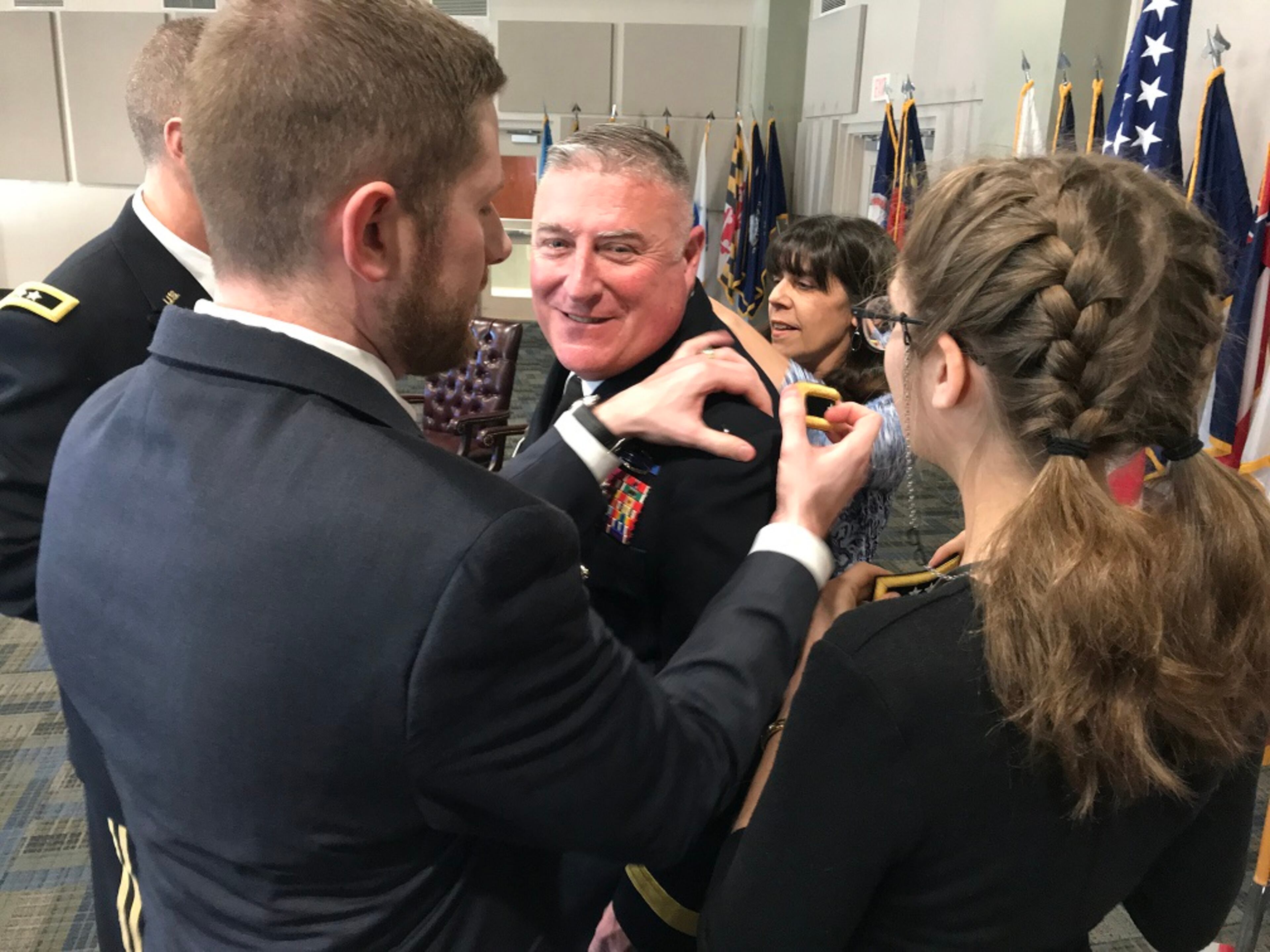 Then-Doraville Police Chief John King’s family attaches his major general rank during his promotion ceremony at the Clay National Guard Center in Marietta. (Jeremy Redmon/AJC)