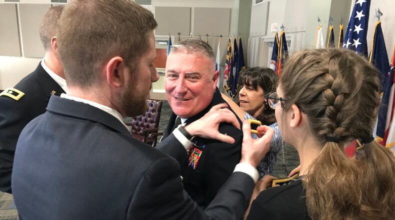 Doraville Police Chief John King’s family attaches his major general rank during his promotion ceremony Friday at the Clay National Guard Center in Marietta. JEREMY REDMON/jredmon@ajc.com