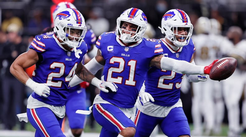 Buffalo Bills free safety Jordan Poyer (21) celebrates his interception with cornerback Taron Johnson (24) and safety Micah Hyde (23) in the second half of an NFL football game in New Orleans, Thursday, Nov. 25, 2021. The Bills won 31-6. (AP Photo/Butch Dill)