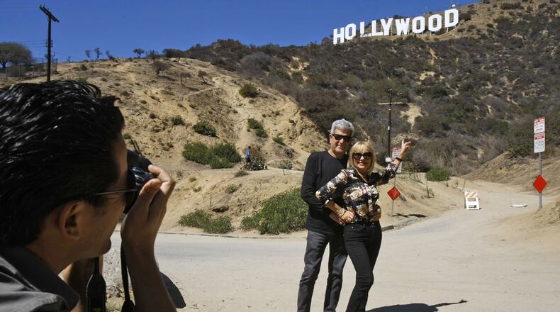 Silvestre Llobet and his wife, Elena Domenech, are photographed by their son, Alejandro Llobet, left, under the Hollywood sign on September 26, 2013, in the Beachwood Canyon area of Los Angeles, Calif. (Gary Friedman/Los Angeles Times/TNS)
