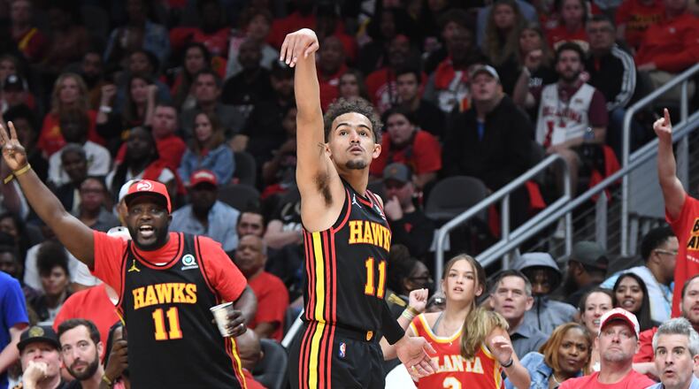 Hawks' guard Trae Young (middle) reacts after hitting a shot. (Hyosub Shin / Hyosub.Shin@ajc.com)