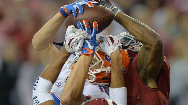 December 5, 2015 Atlanta - Florida Gators wide receiver C.J. Worton (18) catches a touchdown pass under pressure from Alabama Crimson Tide defensive back Minkah Fitzpatrick (29) and Alabama Crimson Tide defensive back Cyrus Jones (right) during Alabama’s 29 - 15 win over Florida in the 2015 SEC Championship at the Georgia Dome on Saturday December 5, 2015. HYOSUB SHIN / HSHIN@AJC.COM