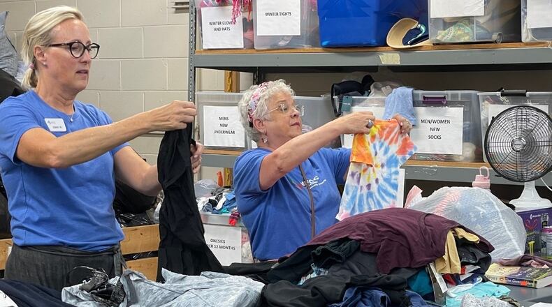 Volunteers at North Fulton Community Charities sort clothing donated to the thrift shop. Revenue from the thrift shop directly supports programs and services in the community. COURTESY NORTH FULTON COMMUNITY CHARITIES