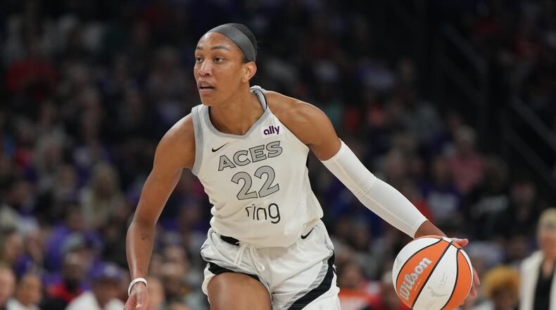 FILE - Las Vegas Aces center A'ja Wilson (22) dribbles against the Phoenix Mercury during the first half of Game 4 of the WNBA basketball finals, Friday, Oct. 10, 2025, in Phoenix. (AP Photo/Rick Scuteri, File)
