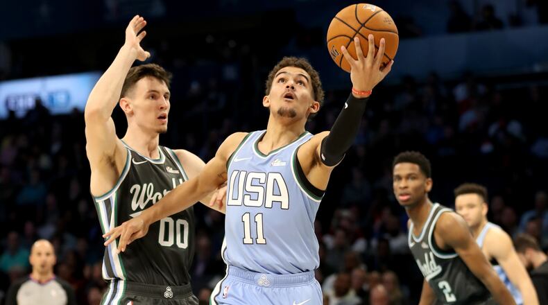 Trae Young of the U.S. Team drives to the basket against Rodions Kurucs #00 of the World Team during the 2019 Mtn Dew ICE Rising Stars at Spectrum Center on February 15, 2019 in Charlotte, North Carolina. (Photo by Streeter Lecka/Getty Images)