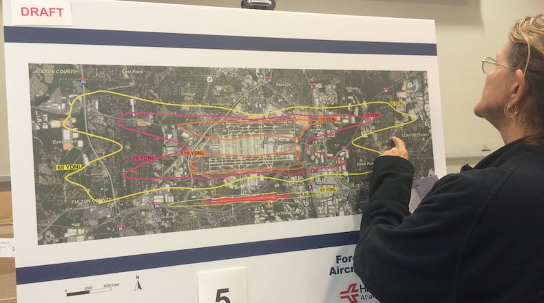 An airport area resident examines a map showing areas affected by airport noise at an open house at Hartsfield-Jackson. Credit: Kelly Yamanouchi.