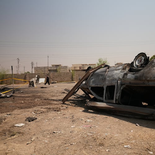 A damaged vehicle at the site of an airstrike on a Popular Mobilization Forces base in Mosul, Iraq, Wednesday, July 29, 2026. (AP Photo/Farid Abdulwahed)