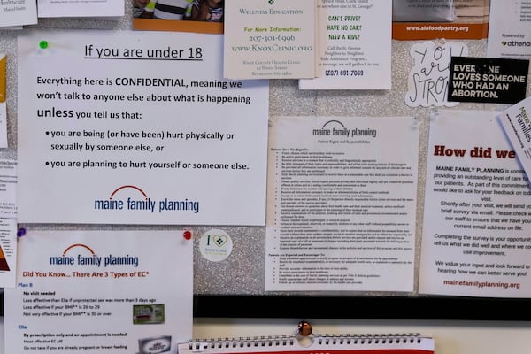 Flyers and documents are posted on a patient bulletin board in an examination room at the Maine Family Planning healthcare facility, July 15, 2025, in Thomaston, Maine. (AP Photo/Charles Krupa)