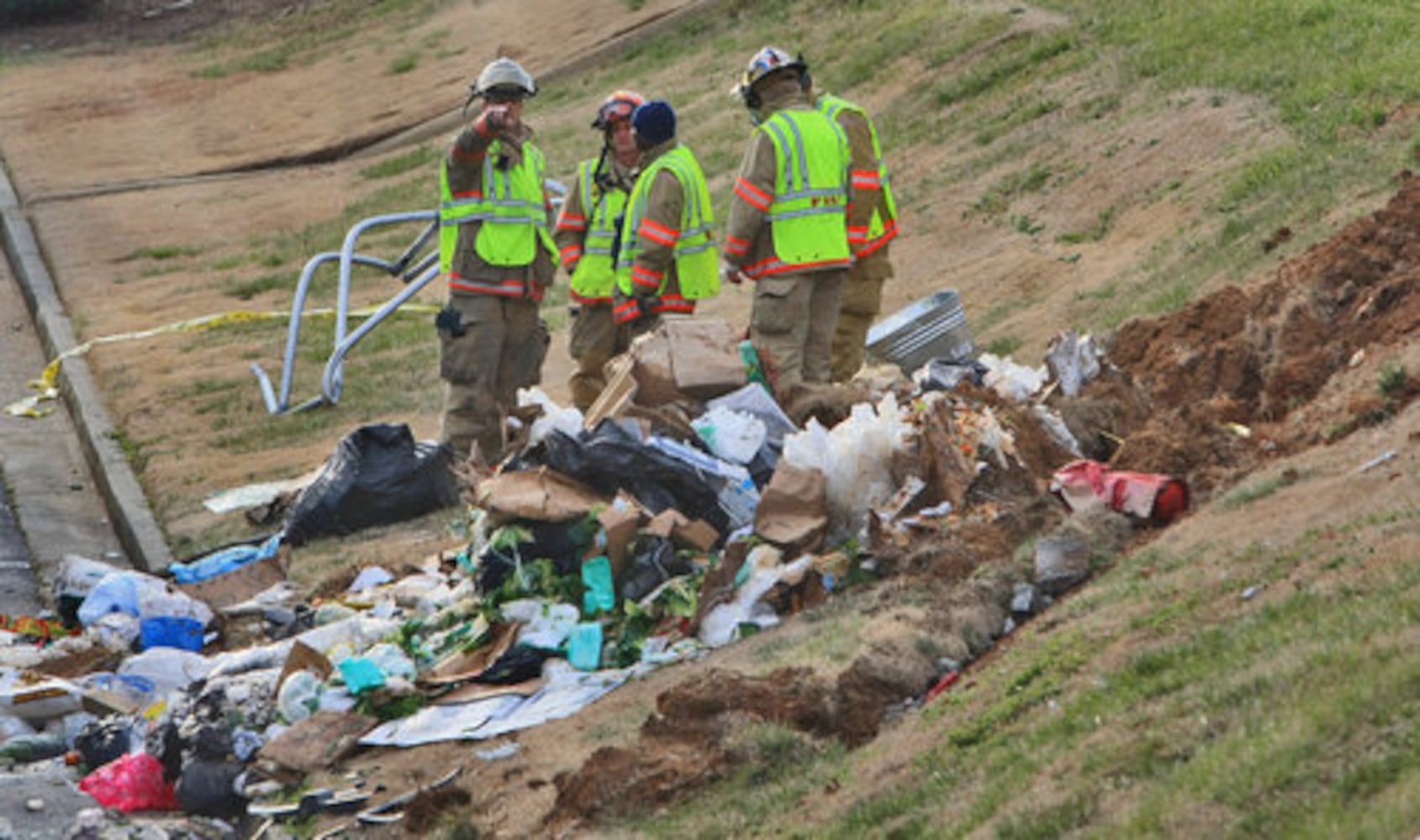 Garbage truck flips down hill, crushes cars