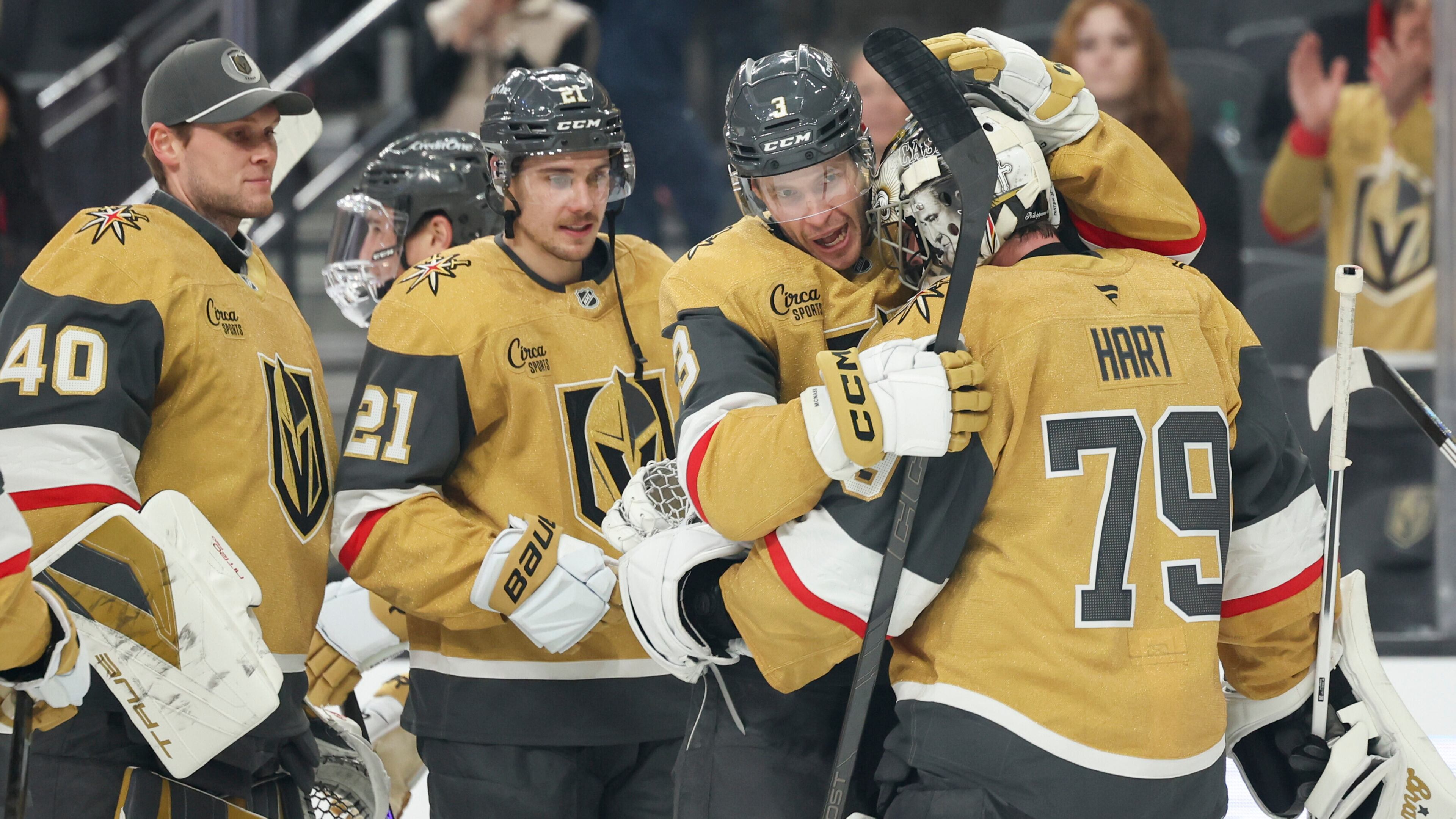 Vegas Golden Knights defenseman Brayden McNabb (3) and goaltender Carter Hart (79) hug after their shootout victory in an NHL hockey game against the Chicago Blackhawks Tuesday, Dec. 2, 2025, in Las Vegas. (AP Photo/Ian Maule)