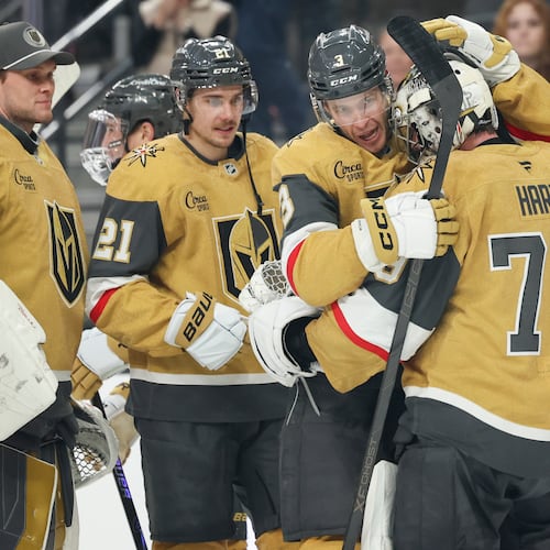 Vegas Golden Knights defenseman Brayden McNabb (3) and goaltender Carter Hart (79) hug after their shootout victory in an NHL hockey game against the Chicago Blackhawks Tuesday, Dec. 2, 2025, in Las Vegas. (AP Photo/Ian Maule)