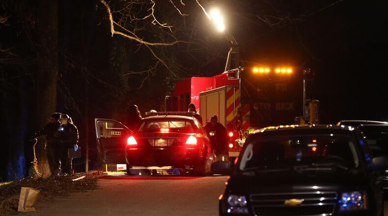 DeKalb County police investigate near the scene of an attempted home invasion that left one person dead and another injured Wednesday, Jan. 13, 2016. Ben Gray / bgray@ajc.com