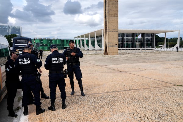 Military police guard the Supreme Court on the second day of the trial of Brazil's former President Jair Bolsonaro in Brasilia, Brazil, Wednesday, March 26, 2025. (AP Photo/Eraldo Peres)