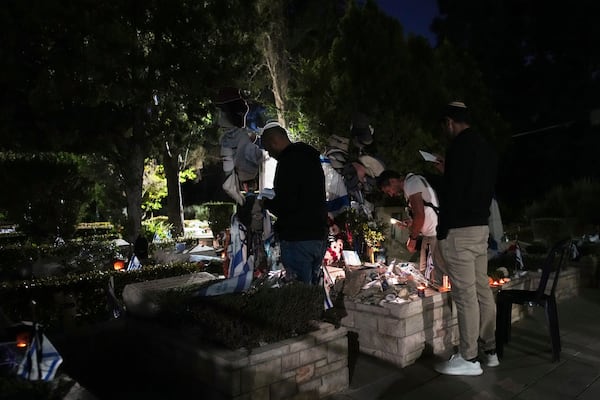 People visit Mount Herzl military cemetery in Jerusalem on the eve of Israel's annual Memorial Day for the fallen soldiers, Tuesday, April 29, 2025. (AP Photo/Ohad Zwigenberg)