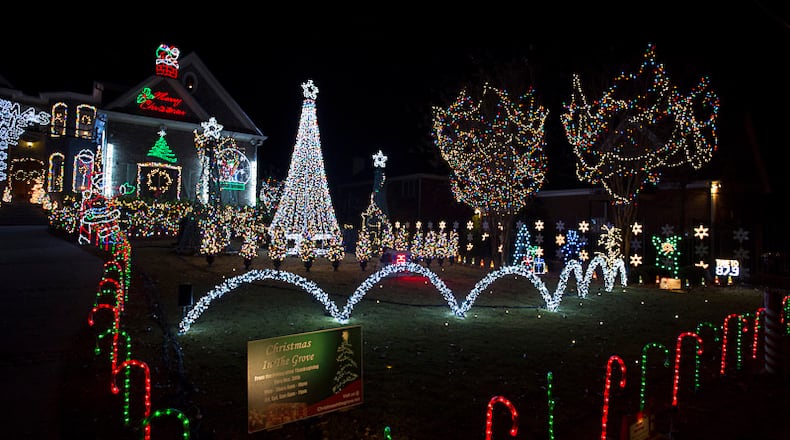 In a file photo, Tony Paradowski shows off his "Christmas in the Grove" lights display at 1428 Oak Grove Drive in Decatur. His family solicits donations to the ALS Association of Georgia, with all proceeds going to the organization.